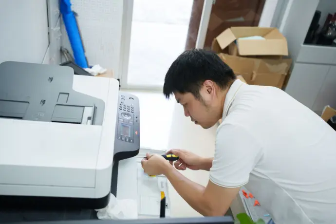 Technician installing toner and cartridges for copier maintenance – Krishna Technologies